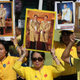 People hold images of the king during his coronation in Bangkok.